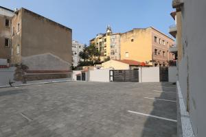 an empty parking lot with buildings in the background at Hidden GEM-Renovated 2023-Studio Garibaldi-perfect for Romantic couples-Best of the Best in Olbia