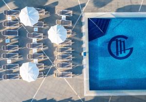 a group of umbrellas next to a swimming pool at Grand Hotel Park in Dubrovnik