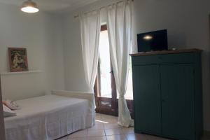 a bedroom with a bed and a large window at B&B Villa Maria Pia in Monopoli