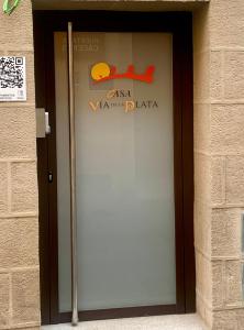 a door to a building with a sign on it at Casa Via De La Plata in Cáceres