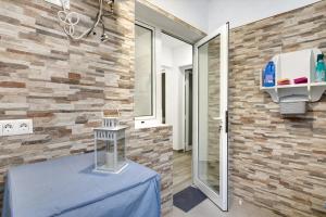 a room with a blue table in front of a brick wall at Vacacional El Atlántico 1 in Granadilla de Abona +13 photos