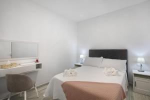 Schlafzimmer mit einem Bett, einem TV und einem Stuhl in der Unterkunft Vacacional El Atlántico 1 in Granadilla de Abona