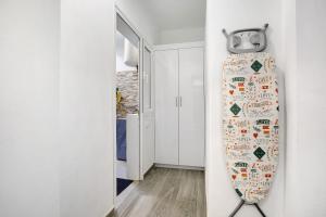 a surfboard hanging on a wall in a room at Vacacional El Atlántico 1 in Granadilla de Abona