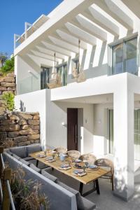 an outdoor dining area with a table and chairs at Villa Alma in Marbella