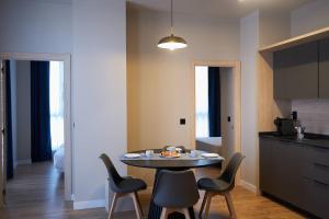 a kitchen with a table and chairs in a room at Hotel-Apartamentos Primus Suites in Valencia