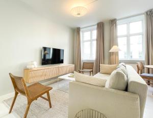 een woonkamer met een bank en een tv bij Beautiful One-Bedroom Flat in CPH City in Kopenhagen