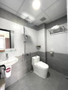 a bathroom with a toilet and a sink at BIG Hotel Huế in Hue