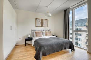 a bedroom with a bed and a large window at Amazing Two Bedroom Flat in Urban Area in Copenhagen