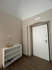 a room with a white door and a white dresser at Il Soprano in Altamura