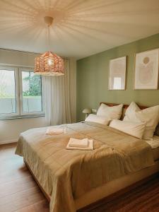 a bedroom with a large bed and a pendant light at MELLoWY 10 Min bis zur Messe KA in Rheinstetten