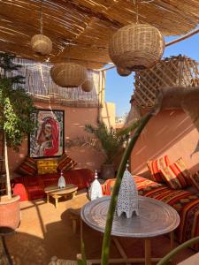 a living room with a couch and a table at Riad Fz Marrakech in Marrakech