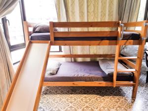 two bunk beds in a room with a window at Clocktower 2 Homestay 2-7 pax at Brinchang, Cameron Highlands in Cameron Highlands