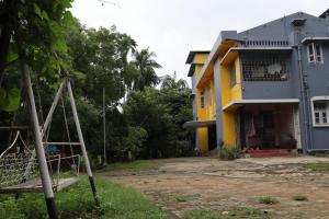 a house with a playground in front of it at Jahnabee's Homestay in Guwahati