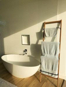 a bath tub and a chair in a bathroom at Walkersons Estate- Outcrop in Dullstroom