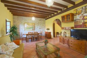 a living room with a couch and a dining room at La Casa del Bosco in Suances