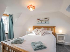 a bedroom with a bed with towels on it at 19 Reidhaven Street in Banff