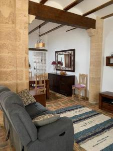 a living room with a couch and a table at Entre montañas y mar, Casa Quim Montesa 