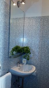 a bathroom with a sink and a mirror at Maestoso Appartamento Turistico in Rome