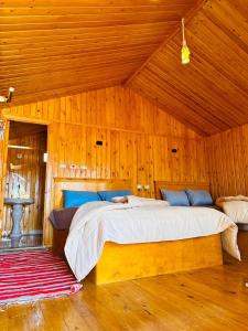 a bedroom with a large bed in a wooden room at Magic land taba camp in Taba