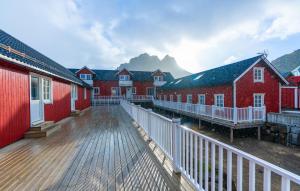 a row of red houses with mountains in the background at Ure Lodge in Sennesvik