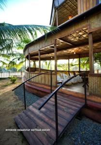 a building with a staircase leading up to it at Riverine Homestay Kochin in Ernakulam