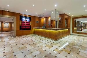 a lobby with a counter and a tile floor at Grand Hotel Guayaquil, Ascend Hotel Collection in Guayaquil