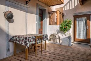 a table on a porch with a table cloth on it at La vecia casa apartament in Denno