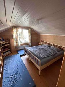 a bedroom with a large bed in a house at Exclusive panorama view of the Oslofjord 