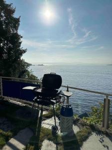 a grill sitting on a balcony overlooking the ocean at Exclusive panorama view of the Oslofjord 