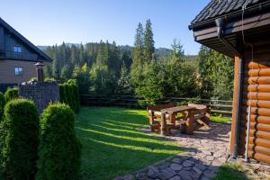 a picnic table and bench in a yard at Apartmány Skihouse Jasná in Demanovska Dolina