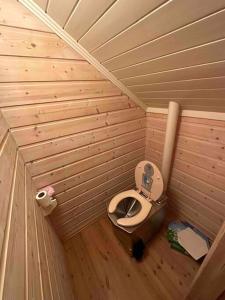 a small bathroom with a toilet in a wooden room at Exclusive panorama view of the Oslofjord 