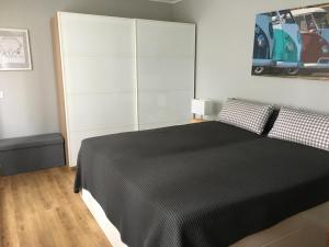 a bedroom with a bed with a black blanket at Bulli-Suite, 2-Zimmer Maisonette-Wohnung in Haan