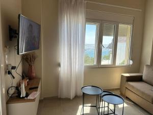 a living room with two tables and a couch at Harma Apartment in Lentas