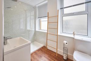 baño con lavabo y aseo y ventana en Host & Stay - Main Street Apartments en Seahouses