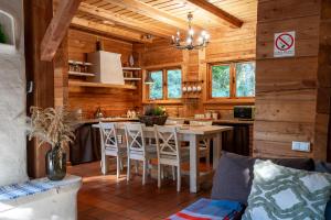 a kitchen with a table and chairs in a cabin at Dom Suwalszczyzna in Suwałki