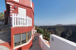 a red and white building with a view of the canyon at Casa Pepa in Santa Brígida
