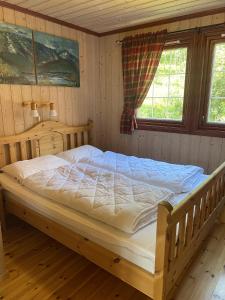 En eller flere senger på et rom på Cottage Yard - cozy Cabin