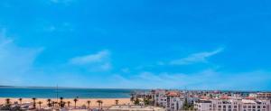 a view of a beach with buildings and the ocean at Luxury Seafront Appartement 6-7p in Agadir