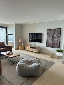 a living room with a couch and a tv at The Pier 27 in Swakopmund