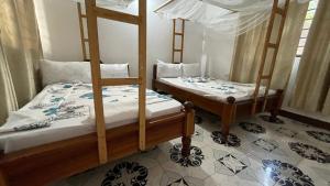 two bunk beds in a room with at Aquarium Beach House in Nungwi