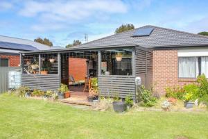 a house with a garden and a patio at Wetland Gem in Wonthaggi