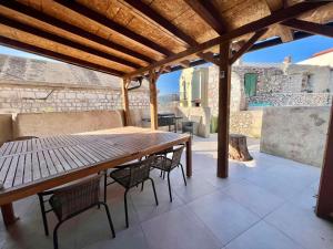 a wooden table and chairs on a patio at Holiday home in Bribir 41512 in Bribir