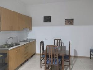 a kitchen with a table and chairs and a sink at Casa Duque in Prado del Rey