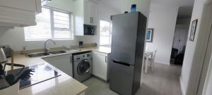 a kitchen with a refrigerator and a washing machine at 19 Tontiki in Ballito