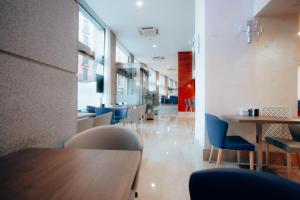 a dining area with tables and chairs in a building at Porcel Ganivet in Madrid