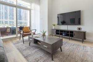 a living room with a tv and a coffee table at Frank Porter - Continental Tower in Dubai