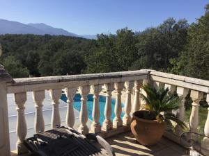 a balcony with a view of a swimming pool at Villa La Cerisaie in Céret