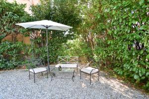 a table and two chairs and an umbrella at VILLARTE in Agliana