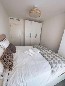 a bedroom with a bed with two towels on it at EMbers La Manga in San Blas +8 photos