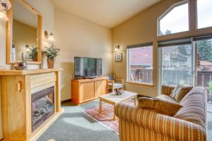 a living room with a fireplace and a tv at Icicle Village Resort 507: Alpenglow Condo in Leavenworth